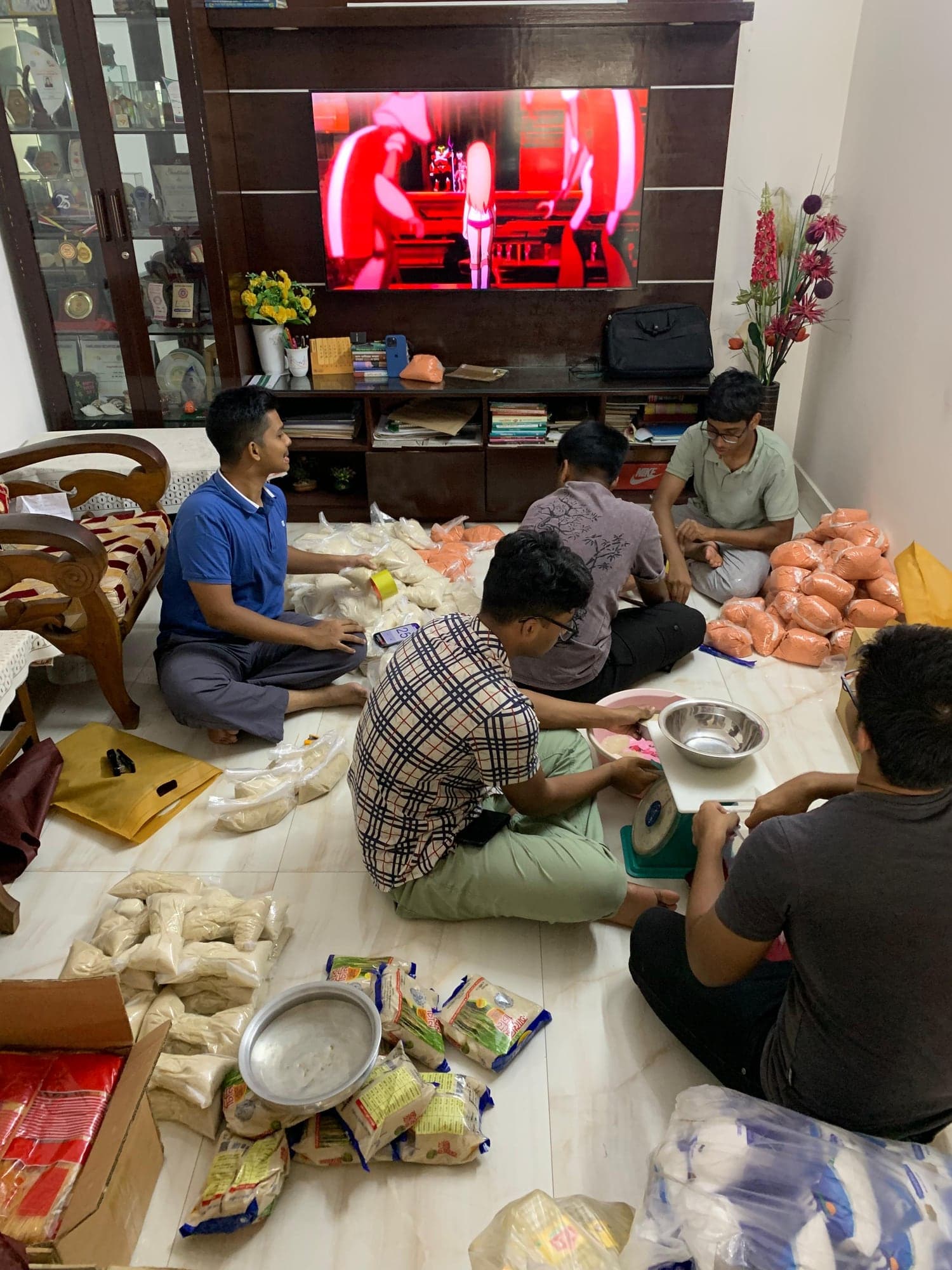 Volunteers weighing and packing food staples for the Eid Food Project
