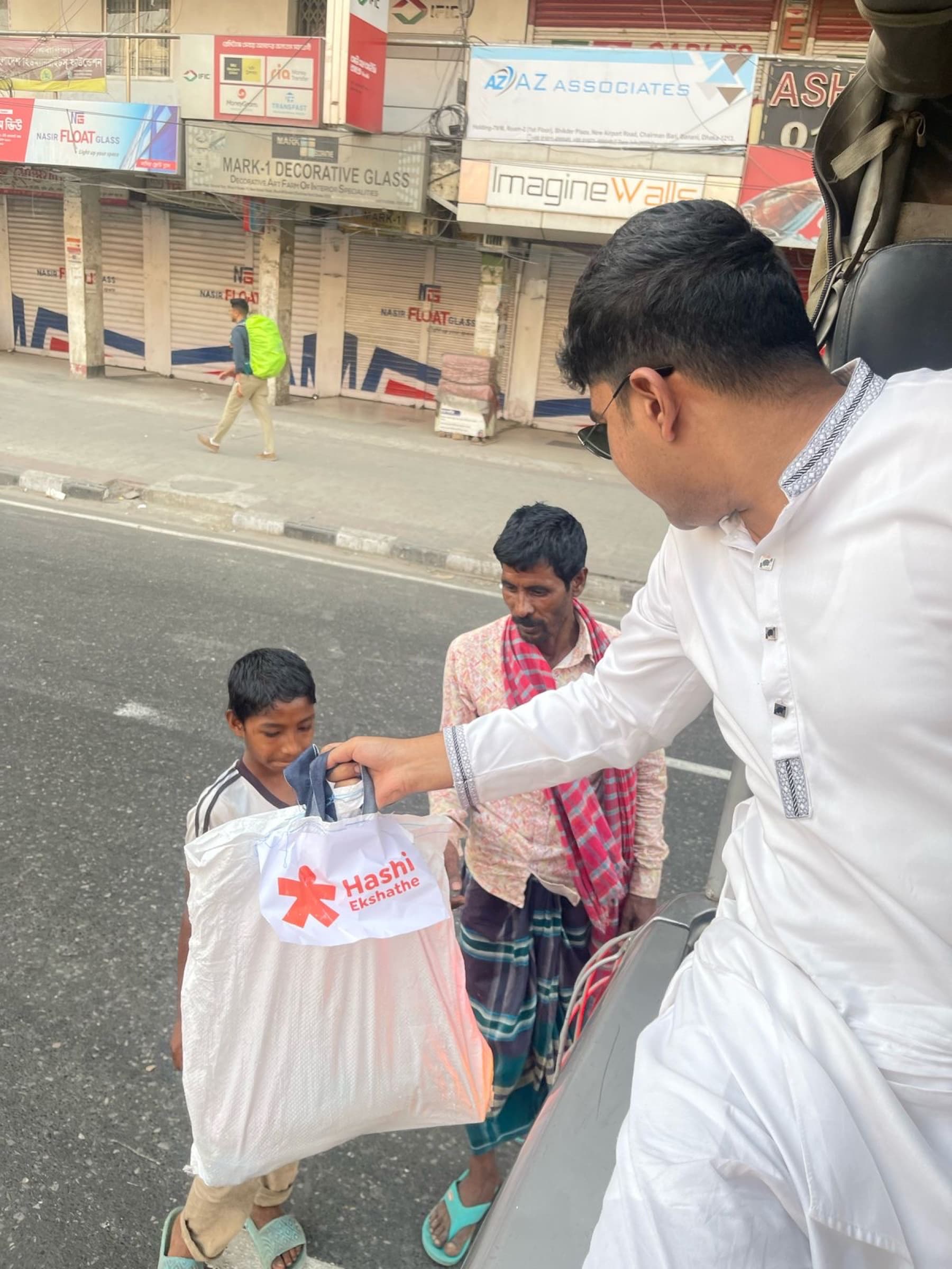 A volunteer delivering a Ramadan food package in Dhaka