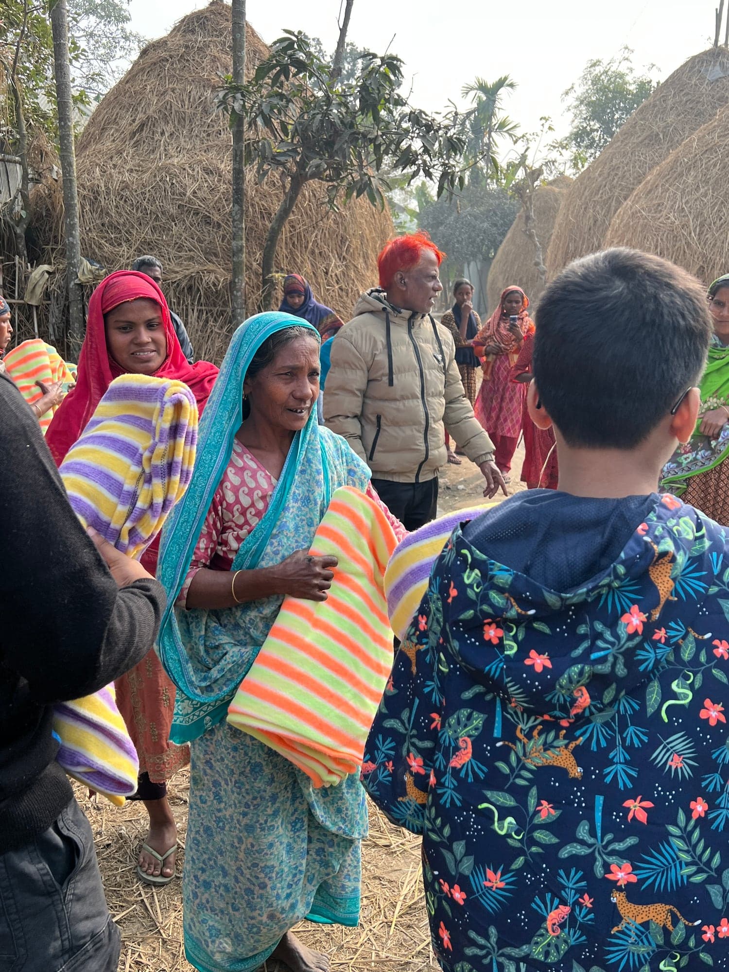 Women holding newly distributed blankets in rural Rangpur
