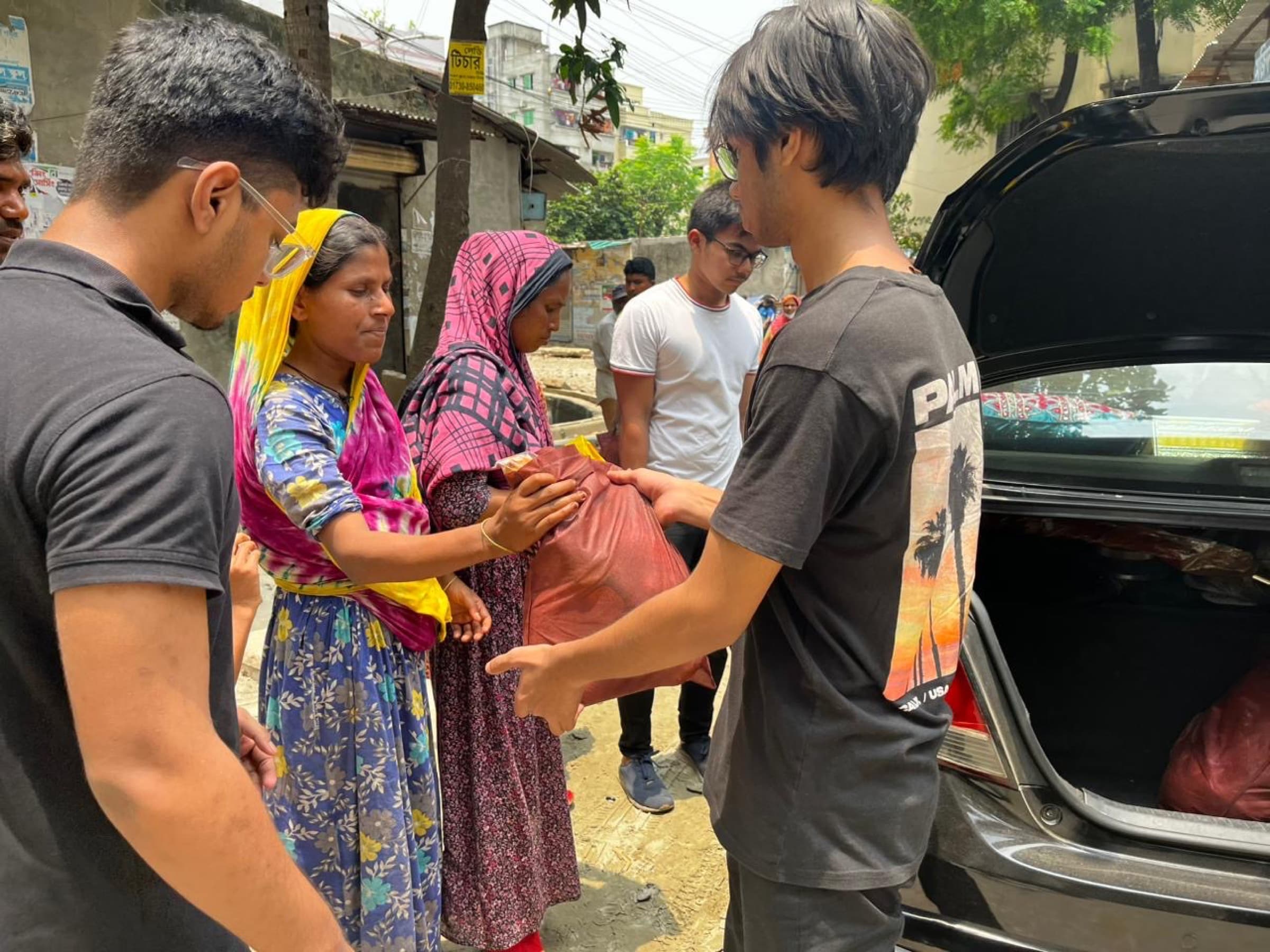 Volunteers delivering an Eid food package in Dhaka