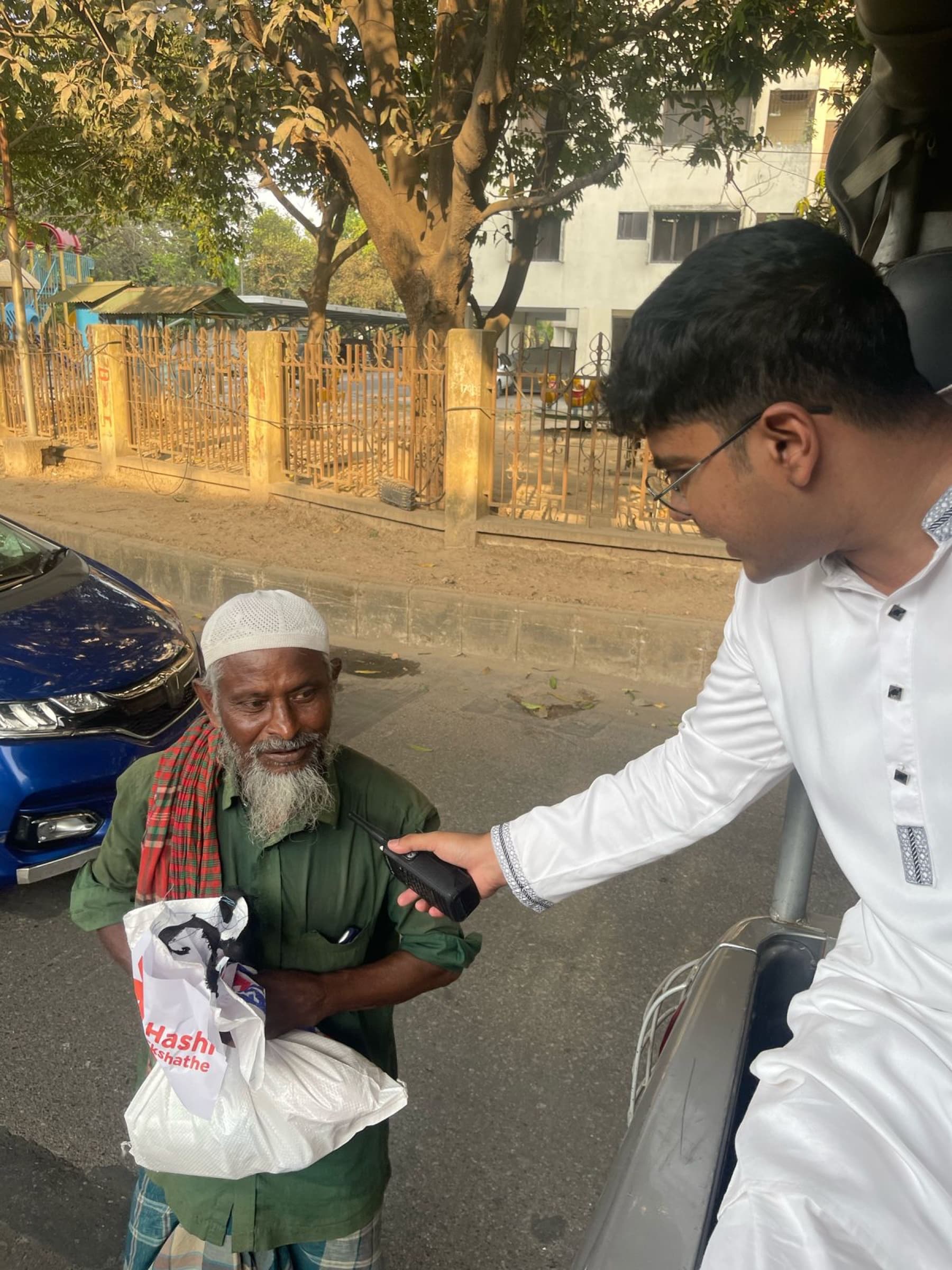 An older resident receiving a Hashi Ekshathe food package