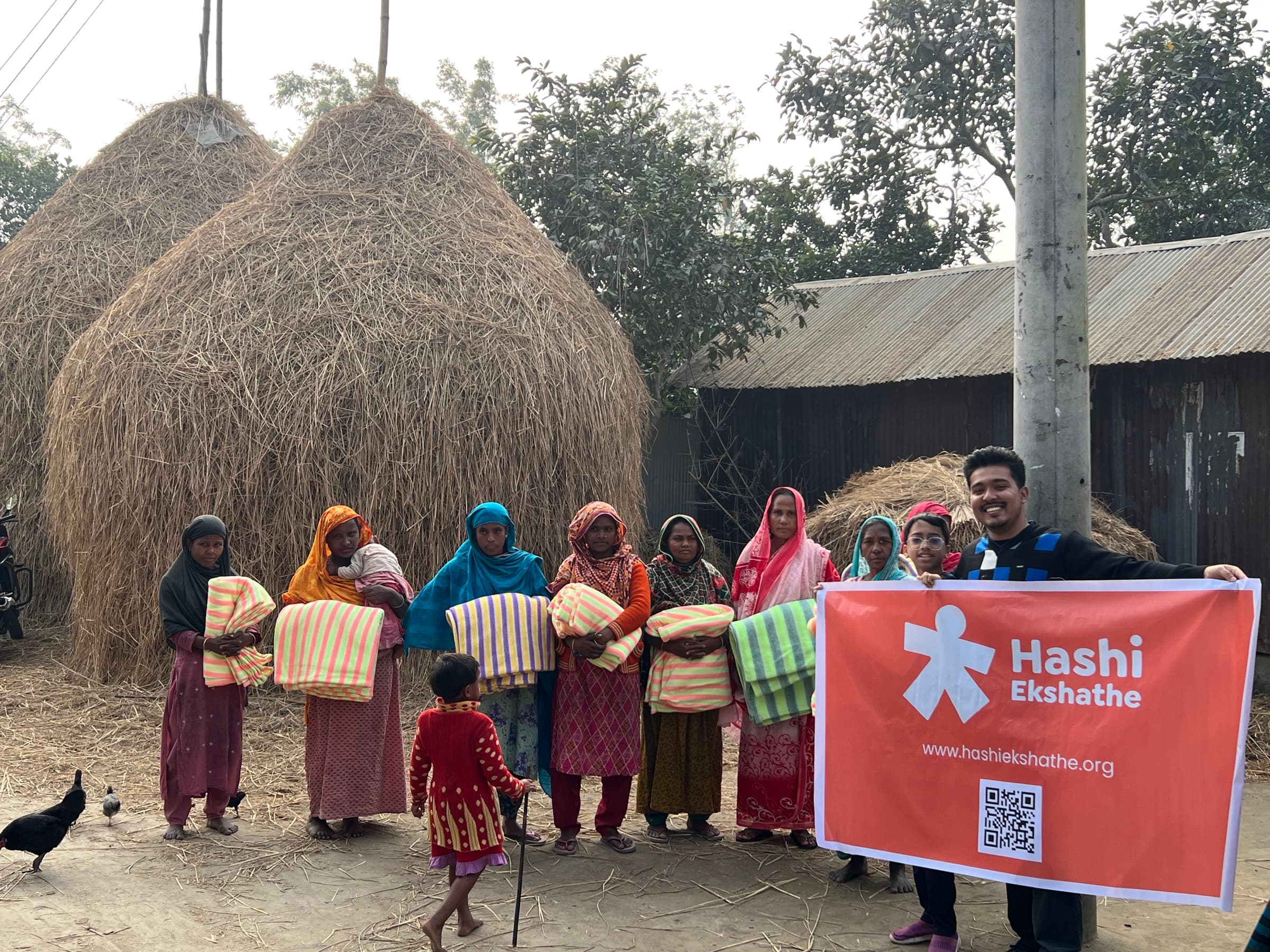 Families and volunteers with blankets during the Rangpur winter distribution