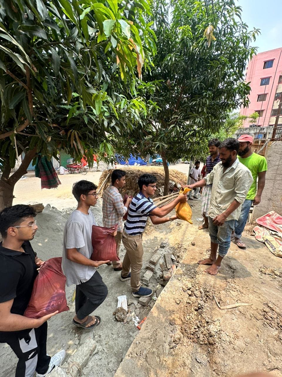 Student volunteers carrying food supplies for distribution